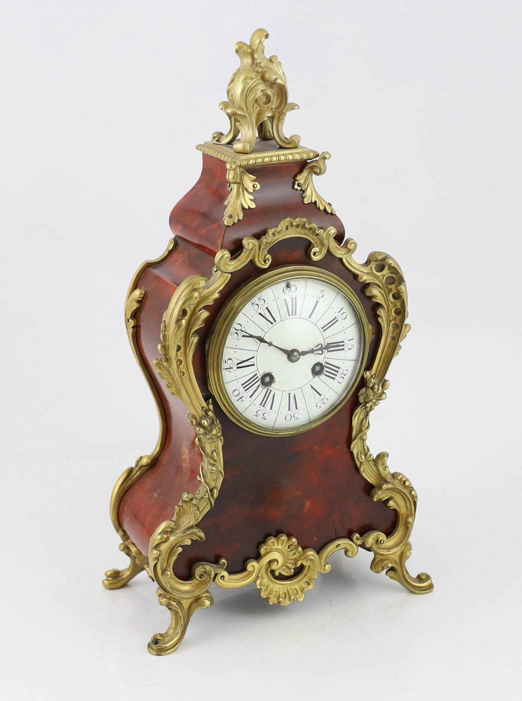 An early 20th century French ormolu mounted red tortoiseshell eight day mantel clock, 22cm wide, 12cm deep, 40cm high